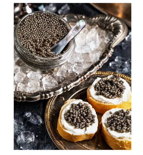 Premium beluga caviar served on ice with mother-of-pearl spoon, showcasing large pearls and luxury caviar presentation