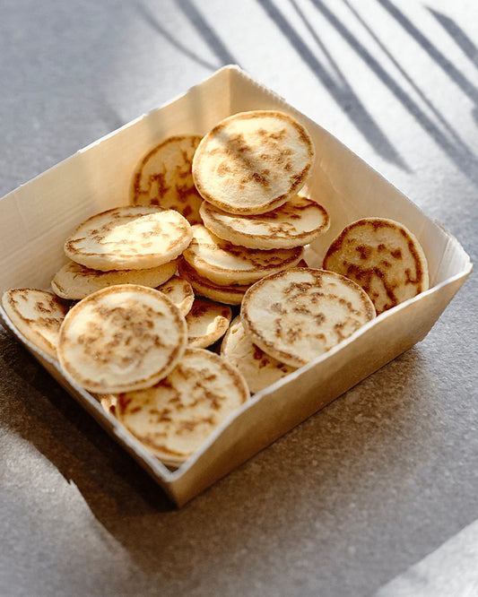 White Toque mini blinis served on a plate